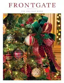 Frontgate Catalog: Luxurious outdoor patio featuring Grade A teak furniture and high-performance fabric cushions in a lush garden setting.