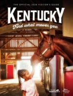 Kentucky Vacation Guide: Scenic view of a Kentucky horse farm with white fences and rolling green hills under a clear blue sky.