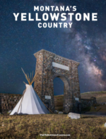 A wide-angle view of the Rocky Mountains in Montana during sunset with a clear river in the foreground.