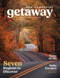 New Hampshire Vacation Guide: A scenic view of the White Mountains in New Hampshire during the autumn season with vibrant orange and red foliage.
