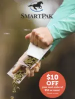 SmartPak Catalog: A physical copy of a horse supply catalog sitting on a wooden stable bench next to a pair of riding boots.