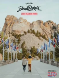 South Dakota Vacation Guide: A scenic view of the granite peaks and pine forests in the Black Hills of South Dakota during a clear summer day.