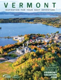 Vermont Vacation Guide: A scenic view of a Vermont landscape featuring a historic white church and colorful autumn trees.