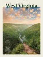 West Virginia Vacation Guide: A scenic view of the New River Gorge Bridge surrounded by lush green forests in West Virginia.