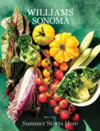 Williams-Sonoma Catalog: A collection of high-end stainless steel cookware and elegant table settings from a kitchen catalog.