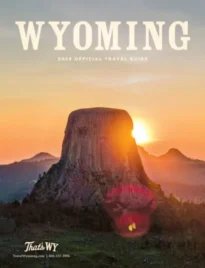 Wyoming Vacation Guide: The jagged peaks of the Grand Teton mountain range reflecting in the calm waters of Jenny Lake during a clear Wyoming sunrise.